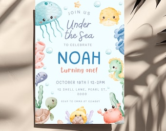 May include: A light blue birthday invitation card featuring watercolor illustrations of a jellyfish, pufferfish, seahorse, turtle, and crab. The text reads: JOIN US Under the Sea TO CELEBRATE NOAH turning one! OCTOBER 19TH | 12-2PM 12 SHELL LANE, PEARL ST, 2000 RSVP TO EMMA AT 1234567.