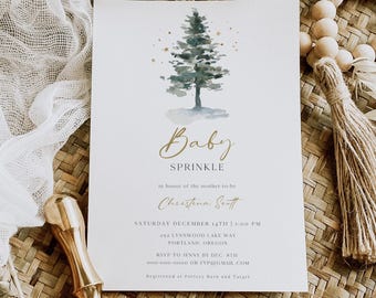 May include: Baby Sprinkle invitation featuring a watercolour Christmas tree design. The invitation includes the text "Baby Sprinkle" and event details. The invitation is on a white background with gold accents.