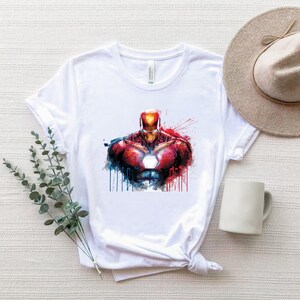Iron Man PNG featuring glowing arc reactor chest design with red and gold armor, comic style superhero artwork perfect for t shirt printing, sublimation and digital crafts