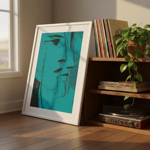 May include: A framed abstract art print featuring a teal and black face profile. The artwork is in a white frame, leaning against a wall. A wooden shelf holds vinyl records, a potted plant, and a record player, creating a vintage aesthetic.