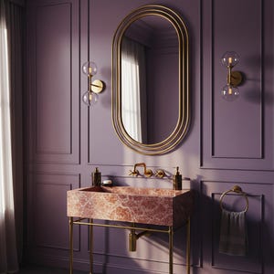 May include: A luxurious bathroom scene featuring a gold-framed oval mirror, a marble sink, and gold fixtures. The sink is supported by a gold stand. The walls are a muted purple, and the lighting fixtures have glass globes.