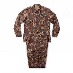 May include: A long-sleeve button-up shirt and matching trousers set featuring a brown, tan, and dark green camouflage pattern. The shirt includes a pointed collar, shoulder epaulets, and two chest pockets with buttoned flaps. The trousers feature side cargo pockets with buttoned flaps and a standard waistband with belt loops.