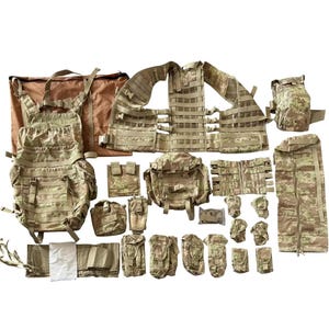May include: A complete tactical gear set in a camouflage pattern. The set includes a backpack, vest, pouches, and other accessories. The color scheme is primarily tan, brown, and green.