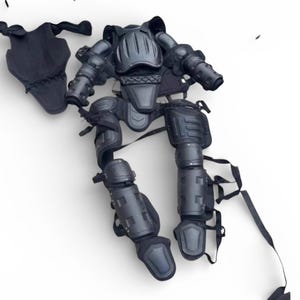 May include: A set of three ceramic mugs with a speckled, matte finish. The mugs are in shades of cream, light gray, and dark gray. Each mug has a simple, minimalist design and a rounded handle.