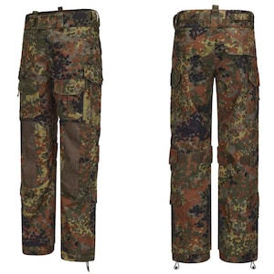 Peut inclure: Pantalon cargo camouflage aux tons de marron, vert et noir. Le pantalon est doté de multiples poches, de renforts aux genoux et d'une ceinture à passants. Conçu pour les activités de plein air et l'usage tactique.