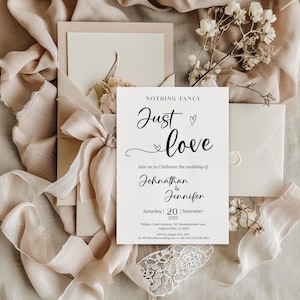 May include: Wedding invitation with the text "NOTHING FANCY Just love" in elegant script. The invitation includes the names Johnathan & Jennifer, the date, and RSVP information. The design features a soft, neutral color palette with ribbons and floral accents.