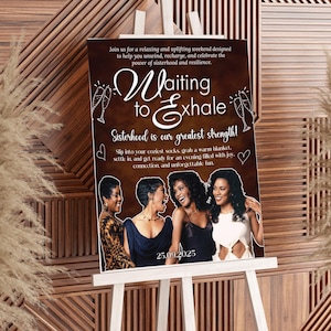 May include: A poster on a white easel with the text "Waiting to Exhale" and the date 25.09.2025. The poster features four women and the words "Sisterhood is our greatest strength!" in a brown background.