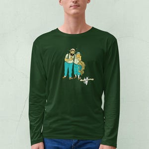 May include: Dark green long-sleeve shirt featuring a cartoon illustration of two people with beards and blue pants. The illustration has a vintage comic book style. The shirt is made of a soft, comfortable material.