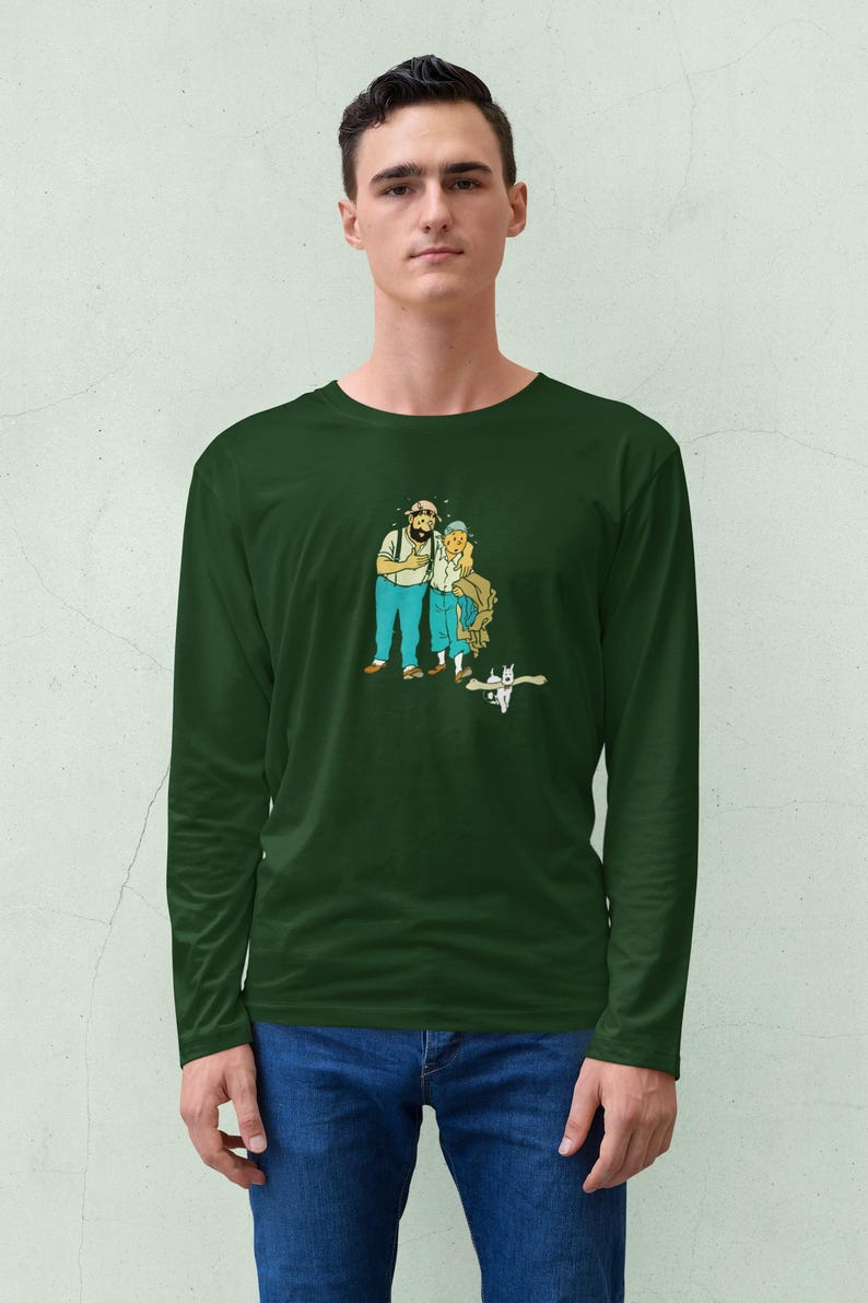 May include: Dark green long-sleeve shirt featuring a cartoon illustration of two people with beards and blue pants. The illustration has a vintage comic book style. The shirt is made of a soft, comfortable material.