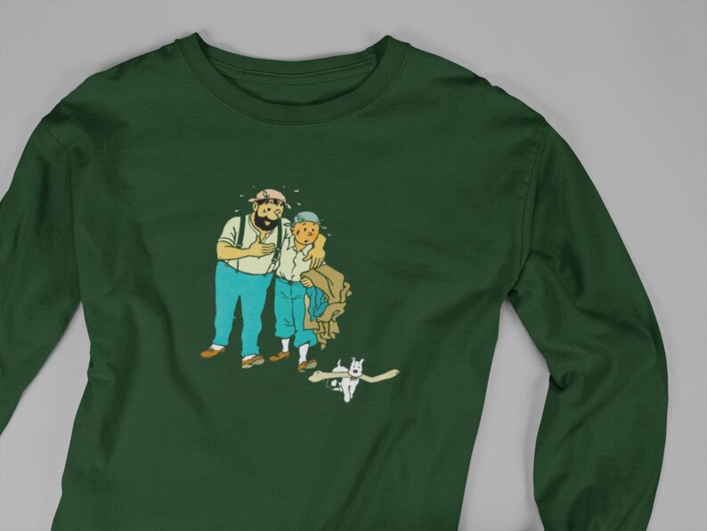May include: Dark green long-sleeve shirt featuring a cartoon illustration of two men and a dog. The men are in blue pants and white shirts. The dog is white with a bone in its mouth. The shirt is made of a soft, comfortable material.