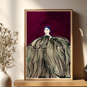 May include: A framed art print featuring a stylized illustration of a person in a voluminous dress with black and white striped details. The background is a deep burgundy. The artwork is displayed on a wooden bench with decorative elements.