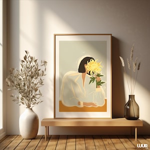 May include: A framed art print featuring a person holding a large yellow flower. The artwork has a minimalist style with soft colors, including white, yellow, and a muted background. The print is displayed on a wooden bench with decorative vases.