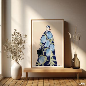 May include: A framed art print featuring a stylized illustration of a person in a dark blue coat adorned with large, light blue floral designs. The person is holding a black handbag. The artwork is set against a neutral background.