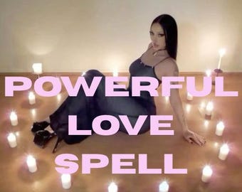 May include: A person in a dark dress sits surrounded by lit candles, with the words "POWERFUL LOVE SPELL" in pink text. The scene is dimly lit, creating a mystical atmosphere. The candles are white and arranged around the person.