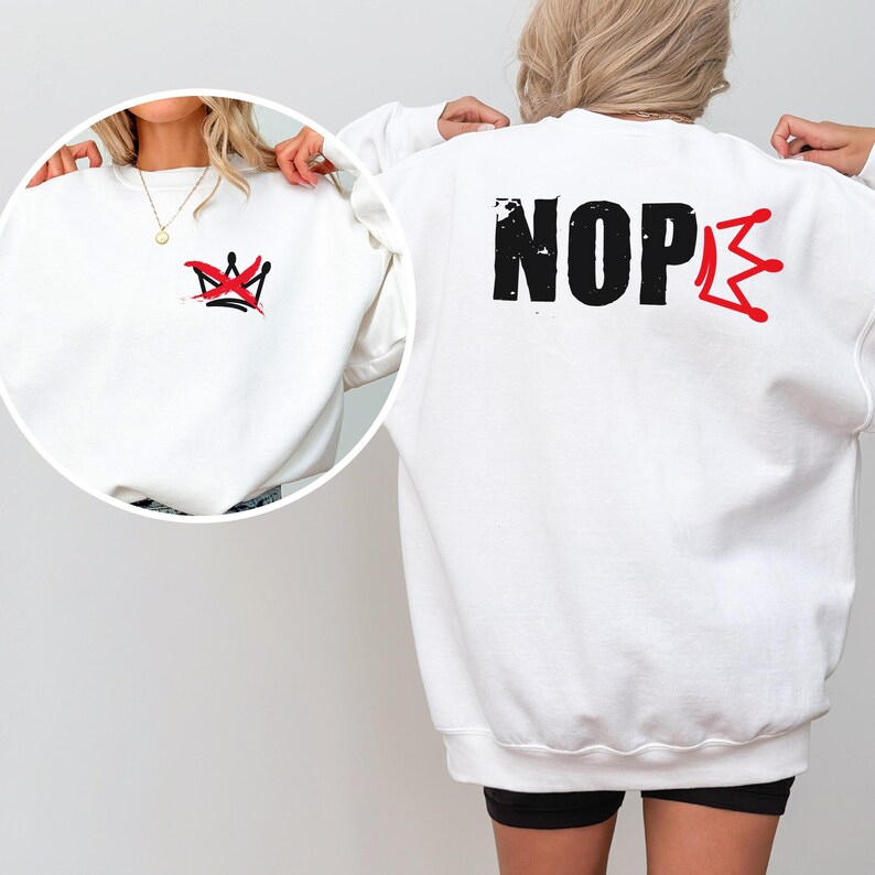 May include: White sweatshirt with a red and black crown graphic on the front and the word "NOPE" with a crown graphic on the back. The sweatshirt is a crew neck style.
