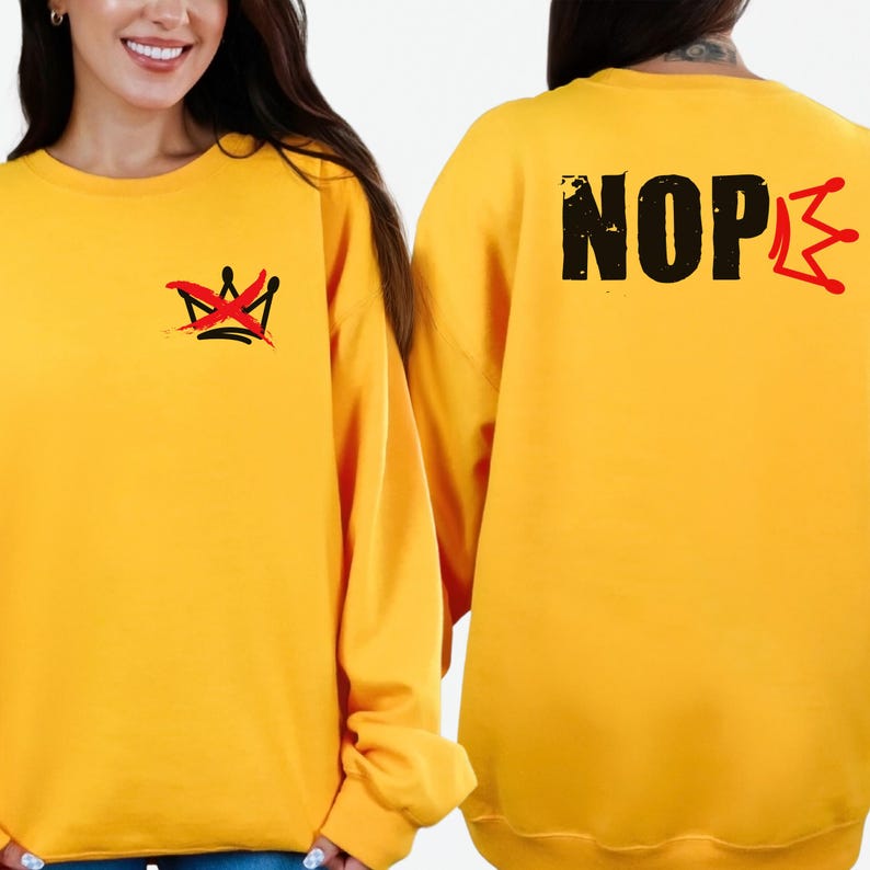 May include: Mustard yellow sweatshirt with a crown graphic on the front and the word "NOPE" with a red slash through the "E" on the back. The crown graphic is black with red accents.