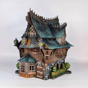 May include: A detailed miniature house with a fantasy aesthetic. The house features a green and brown roof, wooden siding, stone accents, and decorative lanterns. The design includes intricate details, creating a whimsical and charming appearance.