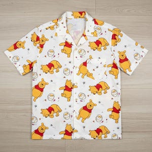 May include: A set of three ceramic mugs with a speckled, matte finish. Each mug features a different color: light blue, cream, and gray. The mugs have a simple, modern design with a rounded shape and a comfortable handle.