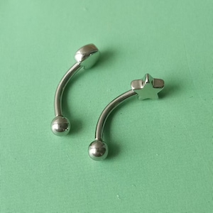 Piercing para ceja con forma de estrella de 16 g: barra de acero quirúrgico con forma de corazón