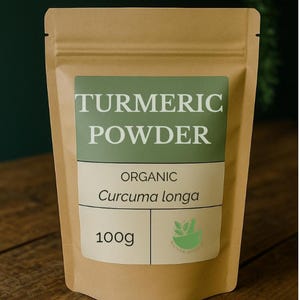 May include: A brown paper bag of turmeric powder. The label reads "TURMERIC POWDER" in white letters on a green background. Below the title, it says "ORGANIC Curcuma longa" and "100g".
