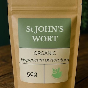 May include: A brown paper bag of St John's Wort. The bag has a green label with the text "St JOHN'S WORT" and "ORGANIC Hypericum perforatum". The bag contains 50g of product.