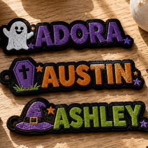 May include: Three rectangular embroidered patches with black borders. The top patch features a white ghost and the name ADORA in purple. The middle patch shows a purple coffin and the name AUSTIN in orange. The bottom patch displays a purple witch hat and the name ASHLEY in green.