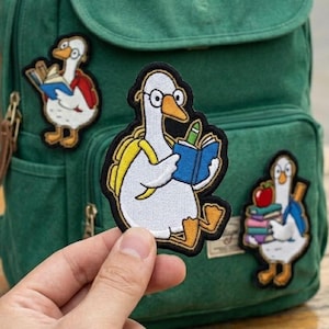 May include: A set of three ceramic mugs with a speckled, matte finish. The mugs are in shades of blue, green, and white. Each mug has a simple, modern design, perfect for coffee or tea.