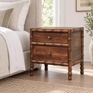 May include: A brown wooden nightstand featuring two drawers with small round metal knobs. The frame is constructed with a bamboo-style design, including vertical posts and horizontal rails that mimic bamboo segments, supported by four legs.