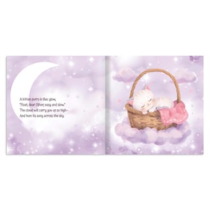May include: An open book illustration with a sleeping white kitten in a wicker basket atop a cloud. The basket has a pink blanket. The background is a soft purple with a crescent moon and text: "A kitten purrs in lilac glow, Float, dear Oliver, easy and slow."