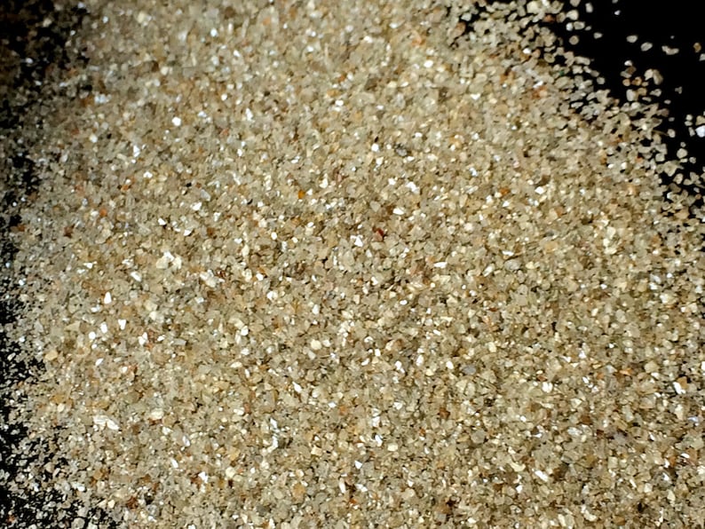 May include: A close-up view of a pile of small, clear, and sparkly diamonds. The diamonds are various sizes and shapes, and they are all very shiny.
