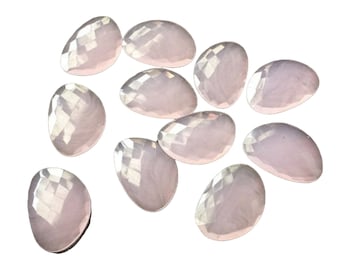 May include: A group of 12 iridescent, light pink, oval-shaped, faceted glass stones.