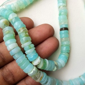 May include: A strand of light blue opal beads, with a silver spacer bead, for jewelry making.