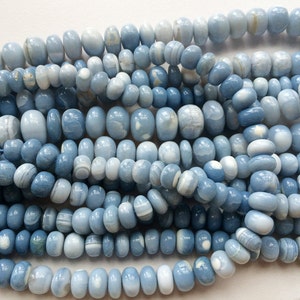 May include: A strand of light blue and white agate beads. The beads are oval shaped and have a smooth, polished finish.