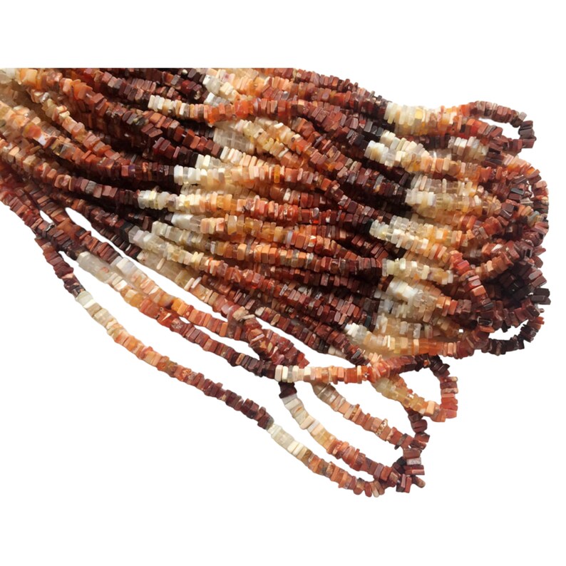 May include: A strand of square-shaped, red, orange, and white gemstone beads. The beads are approximately 4mm in size and have a natural, irregular shape.