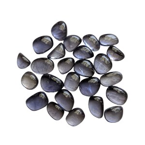 May include: A collection of tumbled black obsidian stones. The stones are smooth and polished, with a dark, glassy appearance.