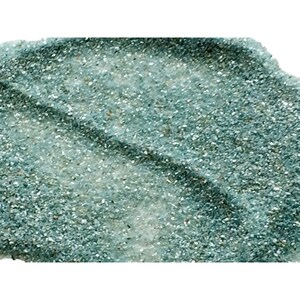 May include: A close-up of teal blue glitter with a shimmery finish. The glitter is spread out in a loose, uneven layer, creating a textured effect.