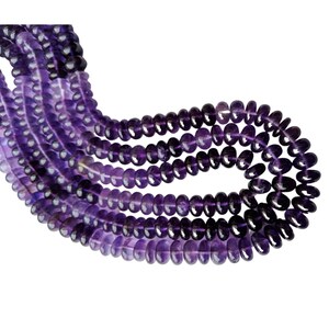 May include: A strand of amethyst beads, featuring a deep purple color with a slight variation in shade. The beads are round and smooth, with a polished finish.