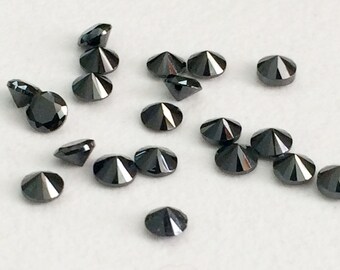 May include: A collection of small, faceted black gemstones scattered on a white surface. The gemstones have a brilliant cut, reflecting light. The overall effect is one of luxury and elegance, suitable for jewelry making.
