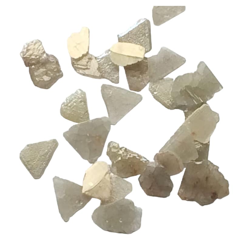 May include: A collection of small, rough, gray and brown diamonds. The diamonds are irregularly shaped and have a variety of sizes.