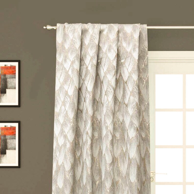 May include: A pair of off-white curtains with a subtle, textured pattern of overlapping feather shapes. The curtains are hung on a silver curtain rod.