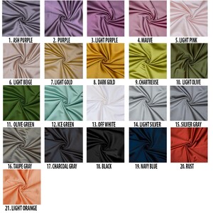 May include: Swatch card displaying 21 different fabric colours. The colours are arranged in rows and labelled with numbers and names. The colours include ash purple, purple, light purple, mauve, light pink, light beige, light gold, dark gold, chartreuse, light olive, olive green, ice green, off white, light silver, silver grey, taupe grey, charcoal grey, black, navy blue, rust, and light orange.
