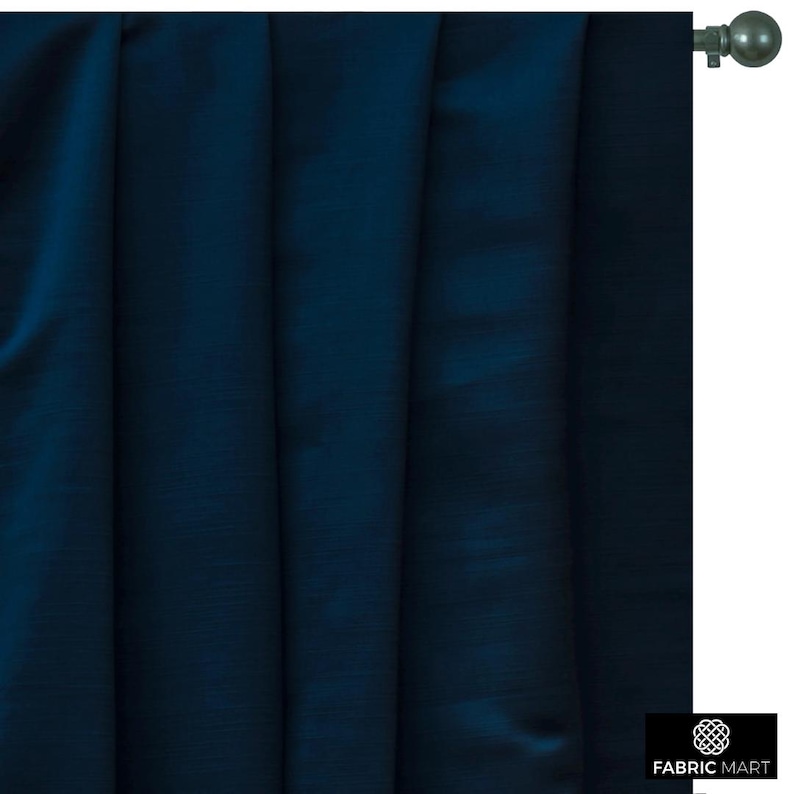 May include: A dark blue curtain panel with a subtle sheen. The curtain is hung on a silver curtain rod with a finial.