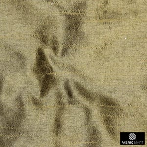 May include: A close-up of a textured, woven fabric in a light brown color. The fabric has a subtle sheen and a slightly wrinkled appearance.