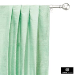 May include: A light green curtain with pleats hanging from a silver curtain rod with a round finial.