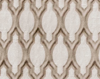 May include: A beige fabric with a raised geometric pattern of overlapping ovals and diamonds.