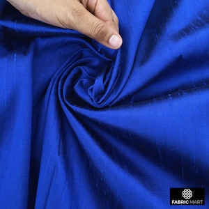 May include: Royal blue silk fabric with a subtle sheen. The fabric is smooth and drapes beautifully.