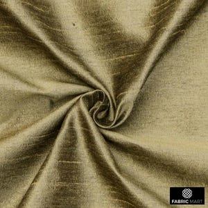 May include: A close-up of a smooth, golden brown fabric with a subtle sheen. The fabric is draped and folded, showcasing its texture and drape.