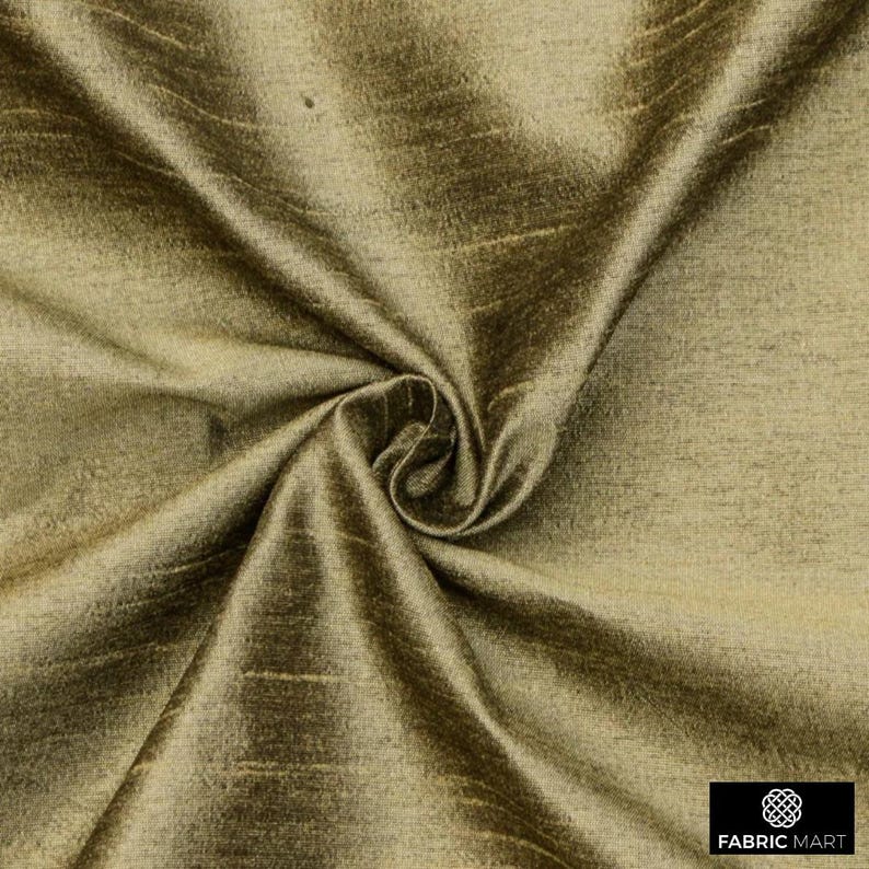 May include: A close-up of a smooth, golden brown fabric with a subtle sheen. The fabric is draped and folded, showcasing its texture and drape.