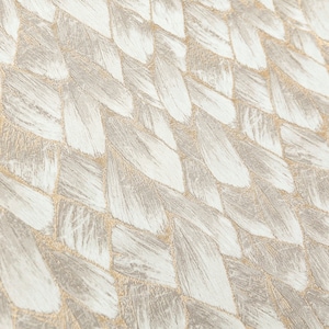 May include: A close-up of a woven fabric with a textured, herringbone pattern. The fabric is a light beige color with a subtle shimmer.