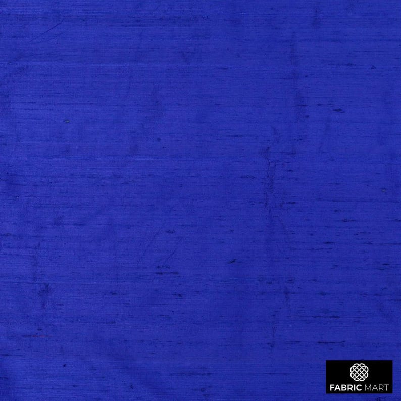 May include: A close-up of a solid royal blue fabric with a subtle woven texture. The fabric has a smooth, silky feel.